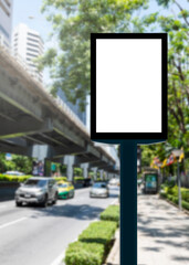 Fototapeta premium Outdoor pole vertical light box billboard with mock up white screen on footpath and clipping path