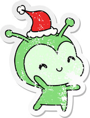 hand drawn christmas distressed sticker cartoon of kawaii alien