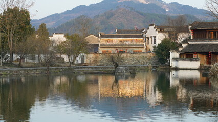 Obraz premium The beautiful traditional Chinese village view with the classical architecture and fresh green trees as background