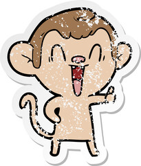 distressed sticker of a cartoon laughing monkey