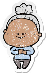distressed sticker of a cartoon happy old woman