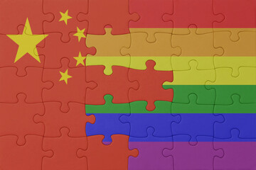 Fototapeta premium puzzle with the flag of rainbow gay pride and china . macro.concept.