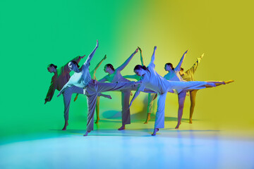 Dance team of young adorable girls moving to the beat of the music on gradient background in neon...