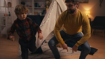 Adorable little boy and his older brother dancing together, having fun together