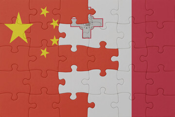 puzzle with the national flag of malta and china . macro.concept.