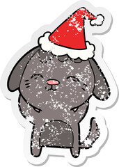 happy hand drawn distressed sticker cartoon of a dog wearing santa hat
