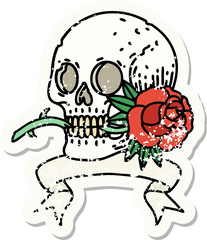 worn old sticker with banner of a skull and rose