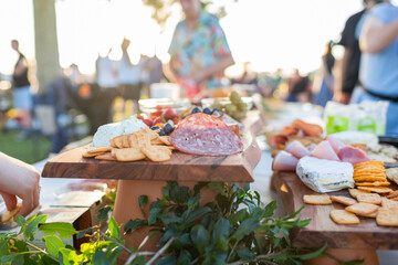 Flat meats and biscuits on grazing table at outdoor party event