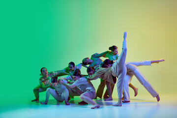 Choreography training of dance group of dancers, girls over gradient background in neon light....
