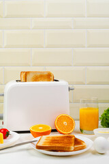 Healthy breakfast in the kitchen. Toaster and bread toast, freshly squeezed orange juice. Cheese,...