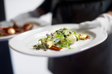 White gloved restaurant service of a cheese-board dessert