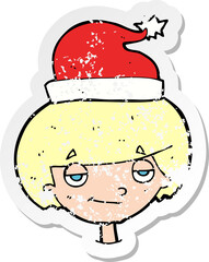 retro distressed sticker of a cartoon boy in santa hat