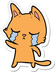 sticker of a crying cartoon cat pointing