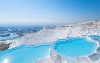 Thermal springs, natural baths Pamukkale, banner landmark of Turkey. Aerial top view blue water in...