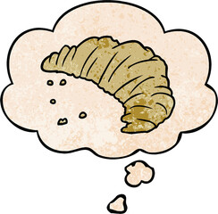cartoon croissant with thought bubble in grunge texture style