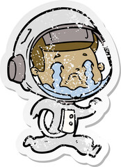 distressed sticker of a cartoon crying astronaut