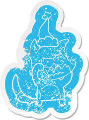 quirky cartoon distressed sticker of a annoyed fox wearing santa hat