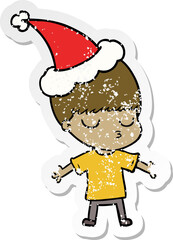 hand drawn distressed sticker cartoon of a calm boy wearing santa hat