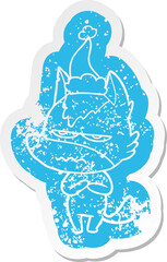 quirky cartoon distressed sticker of a annoyed wolf wearing santa hat