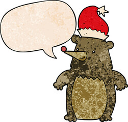 cartoon bear wearing christmas hat with speech bubble in retro texture style