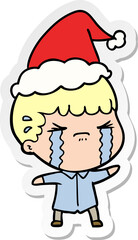 hand drawn sticker cartoon of a man crying wearing santa hat