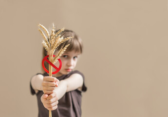 Banner for International day of celiac disease. Child holding crossed sprinklers. No wheat concept.