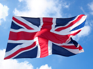 British union flag flying against a blue cloudy sky