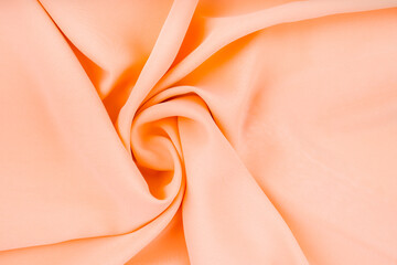The pastel orange color cloth waves background texture.