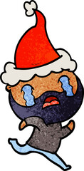 hand drawn textured cartoon of a bearded man crying wearing santa hat