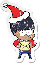 nervous hand drawn distressed sticker cartoon of a boy wearing santa hat