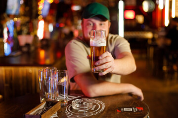 Close up of man drinking beer in a bar
