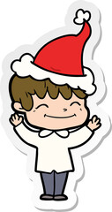 hand drawn sticker cartoon of a happy boy wearing santa hat