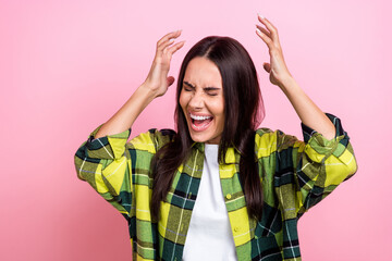 Photo of furious displeased woman dressed plaid shirt rising hands arms screaming isolated pink color background