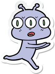 sticker of a cartoon three eyed alien