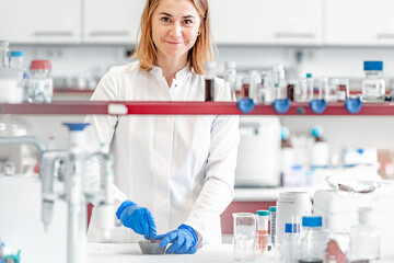 a female student at the science faculty of the university conducts biochemical research in the laboratory