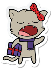sticker of a cartoon cat with christmas present