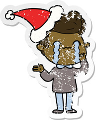 hand drawn distressed sticker cartoon of a man crying wearing santa hat