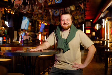 portrait of cheerful happy ginger man in the pub