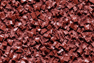 Background from pieces of grated milk chocolate. Chocolate texture. Generative AI
