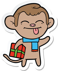 sticker of a funny cartoon monkey with christmas present