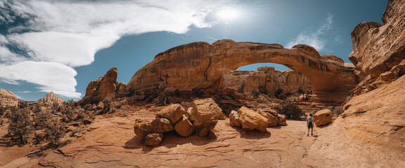 Sunny view of the Hickman Bridge of Capitol Reef National Park at Utah. Young tourist enjoying the...