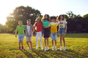 Happy children having fun on summer vacation. Bunch of school kids playing together and enjoying...