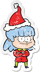 hand drawn distressed sticker cartoon of a smiling woman wearing santa hat