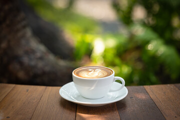Background Coffee cup and beans on old kitchen table. Coffee cup in coffee shop.