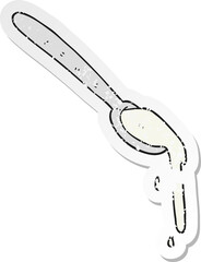 retro distressed sticker of a cartoon spoonful