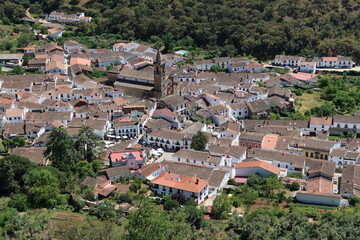 Fototapeta na wymiar Alajar, Huelva, Spain, April 23, 2023: General view with the Church of San Marcos in the center of the white village of Alajar, Huelva, Spain
