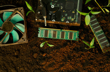 Electronic waste concept, computer parts in the soil. Computers becoming natural occurrence
