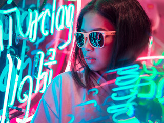 Lonely y2k girl sitting in a retro diner with colorful neon signs eating dinner wearing yellow sunglassess