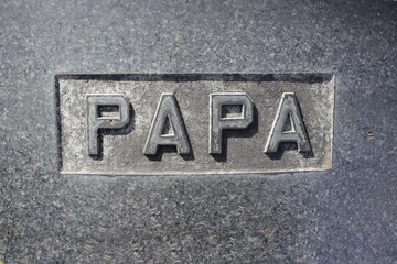 Papa hand carved into natural stone.