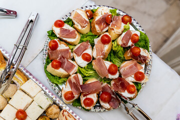 Various delicious canapés served in a plate on the table